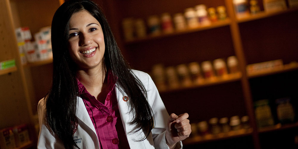 female student in model pharmacy