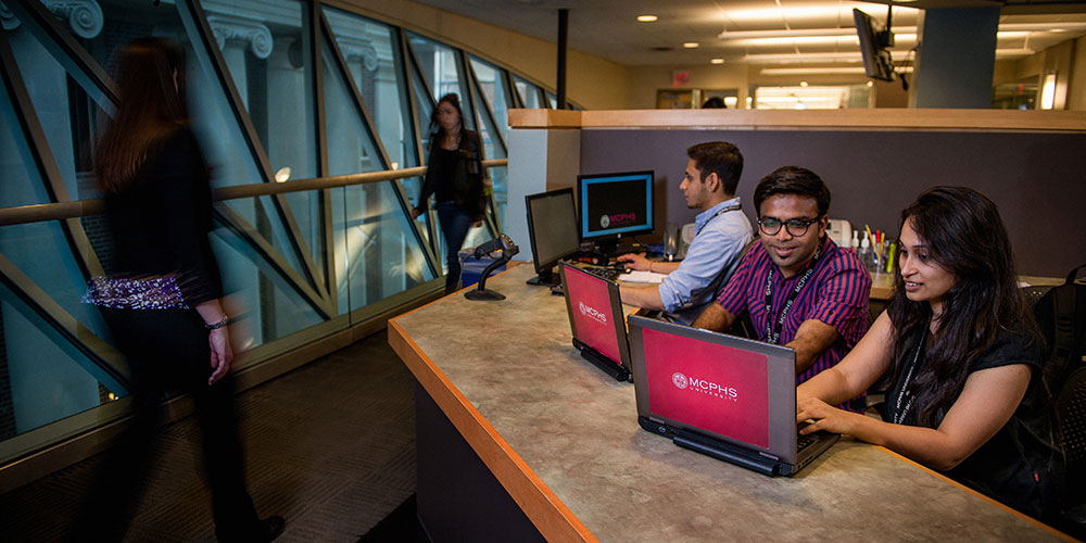 Students chatting at front desk