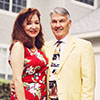 Man and woman standing in front of house