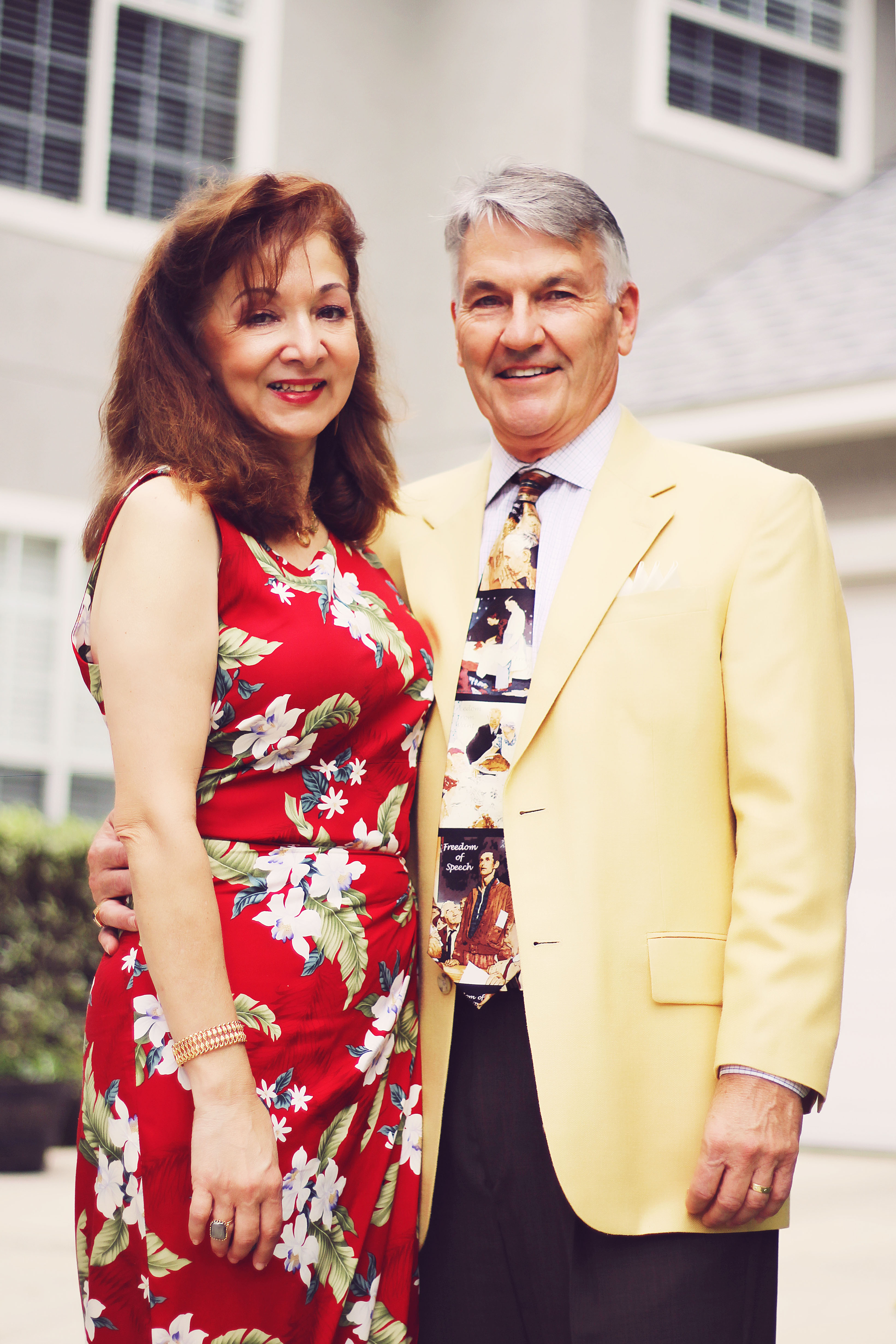 Man and woman standing in front of house
